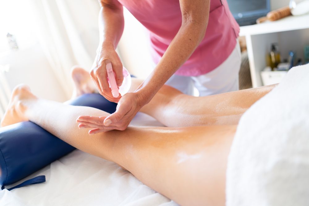 Masseuse working on calves of woman in spa