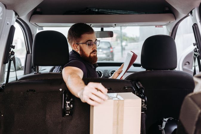 Courier preparing cartons for express delivery