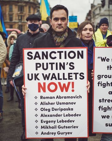 London, England, United Kingdom - March 5 2022: Man holding sign at protest about sanctions