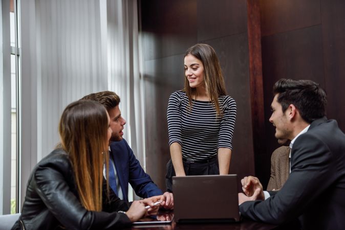 Female giving a talk to her colleagues at work