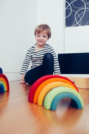 Boy playing with wooden construction pieces