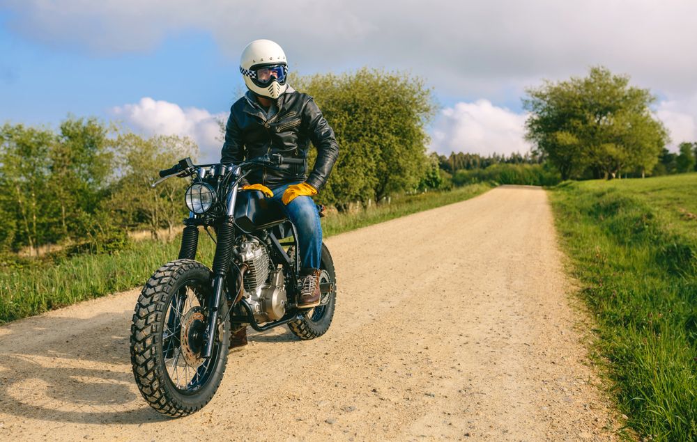 Man with helmet riding custom motorbike