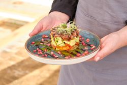 Crop cook with plate of tasty tartar