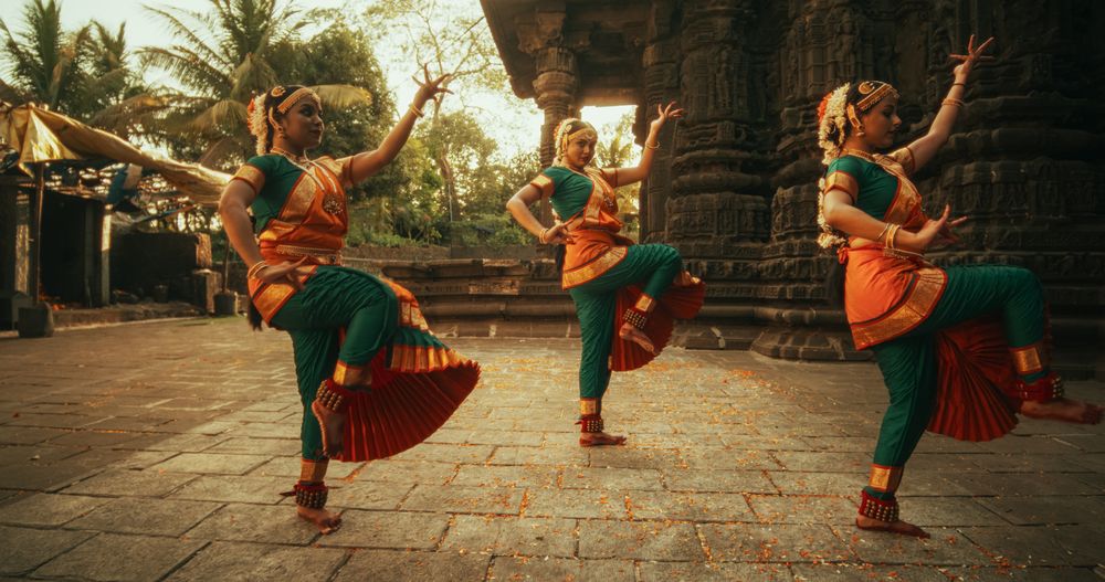 Portrait of Indian Women in Traditional Clothes Dancing Bharatanatyam in Colourful Sari.
