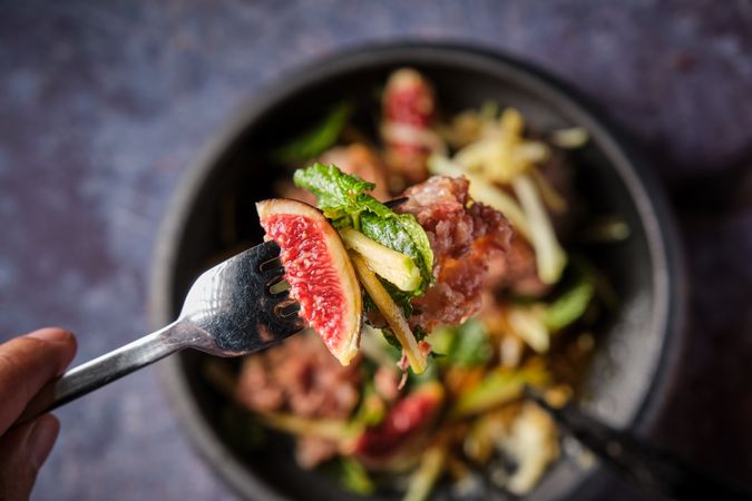 Savory pork trotter with fig and vegetables on fork