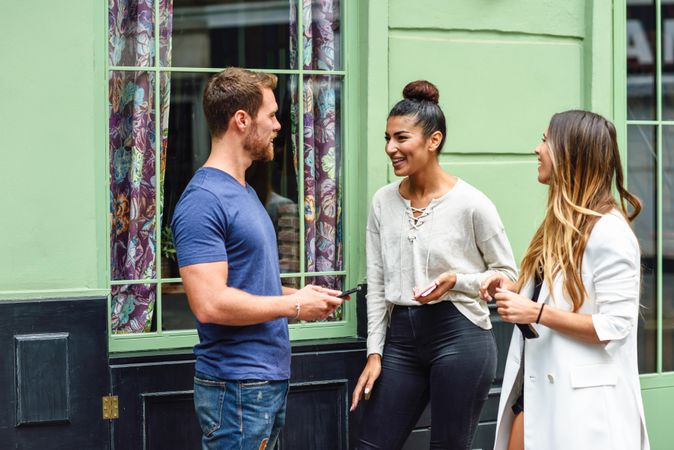 Multiracial group of friends talking outside