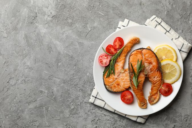 Composition with tasty grilled salmon on gray background, top view