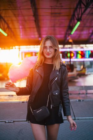 Trendy woman in underpass with cotton candy