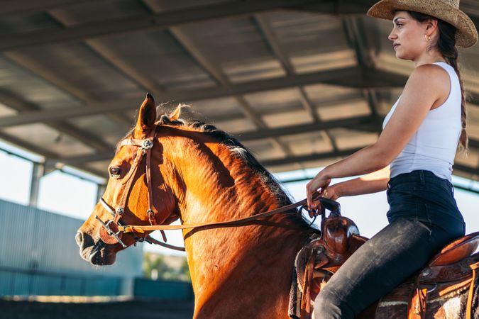 Woman riding a horse in an equestrian center