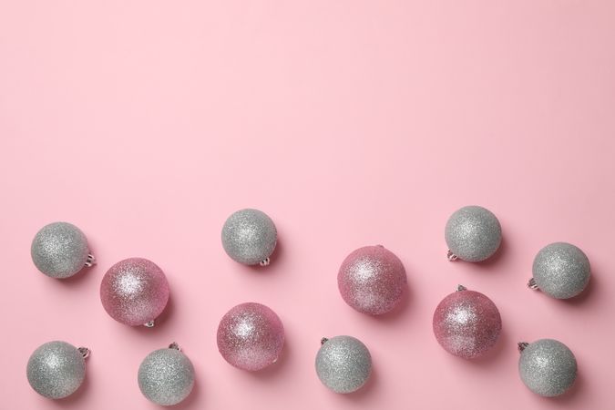 Composition with Christmas balls on pink background, space for text