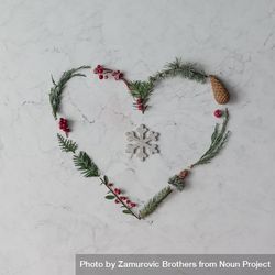 Heart shape made of winter foliage with snowflake 5w3GL5