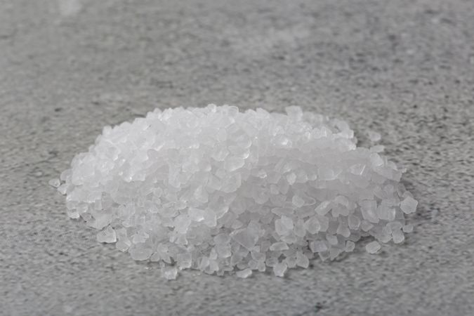 Handful of coarse salt on the table.