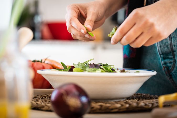 Woman preparing vegetable salad