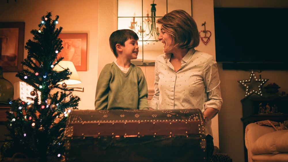 Mother and son opening magic chest on Christmas Day
