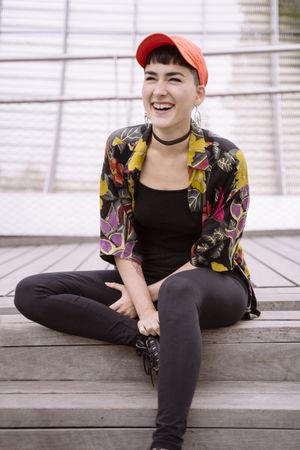 Women in colorful shirt sitting on street