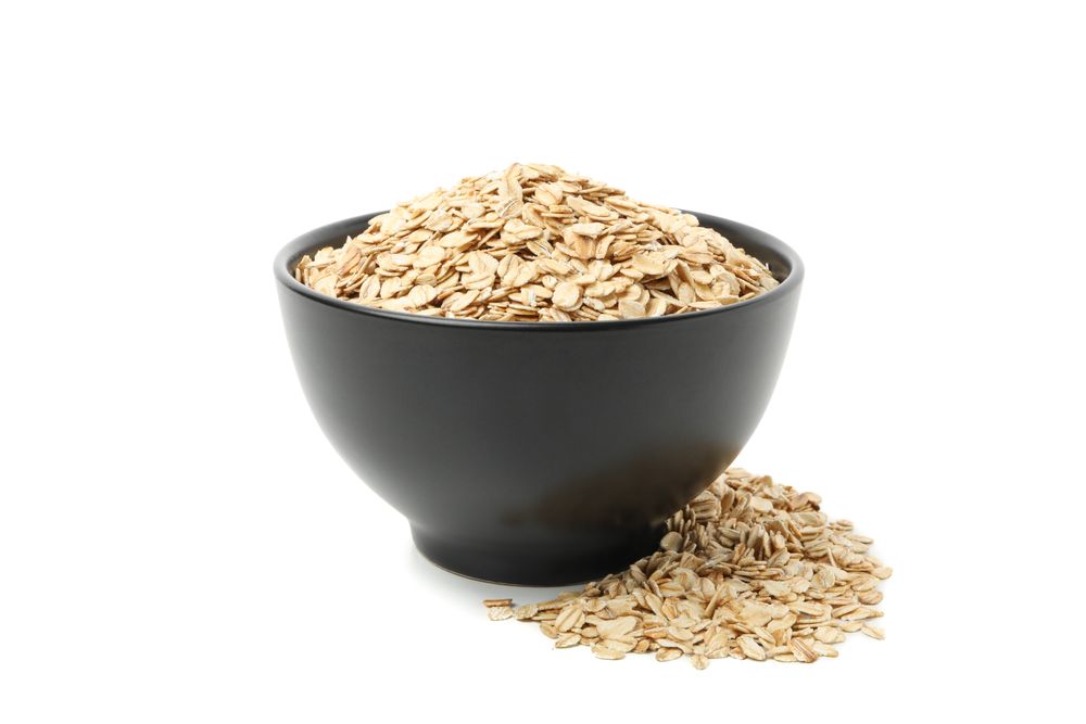 Bowl with oatmeal flakes isolated on plain background