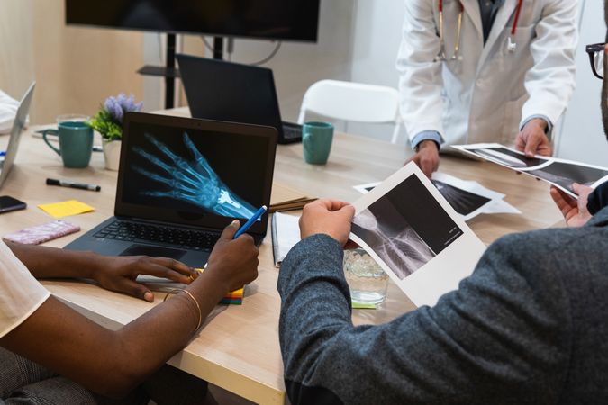 Crop doctors examining x rays in clinic