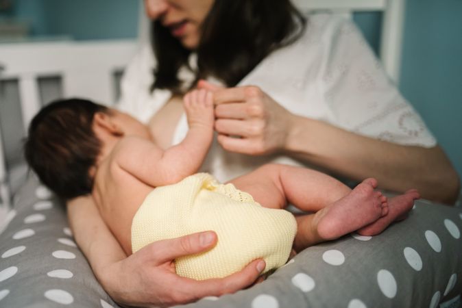 Mother feeding baby at home