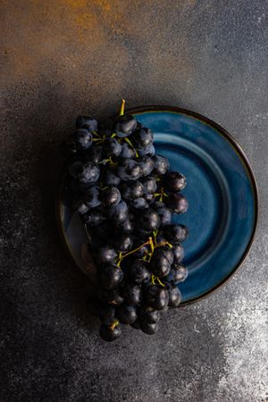 Plate of red grapes on navy plate