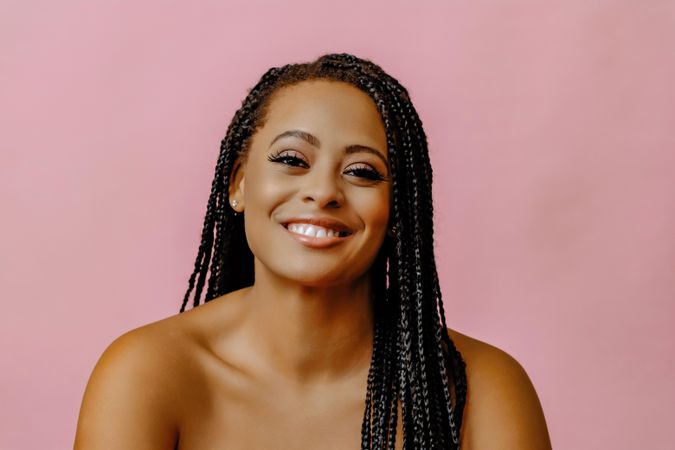 Studio portrait of smiling female with braided hair