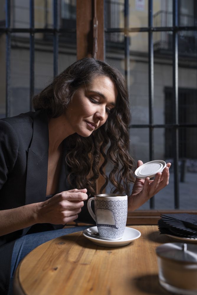 Young female with tea cup in cafe