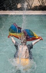 Excited gay man in swimming pool