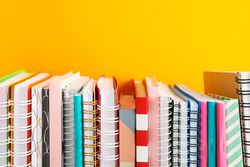 Stack of colorful books against background, space for text
