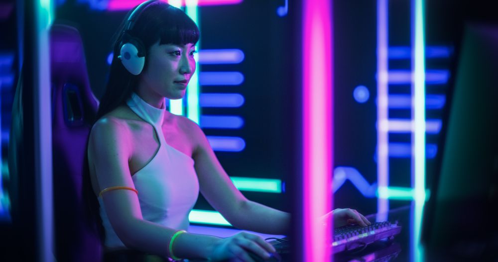 Video Gamer Playing Games and Chatting with Internet Followers in a Futuristic Neon Studio