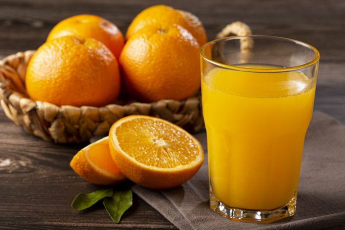 Glass with orange juice on the table.