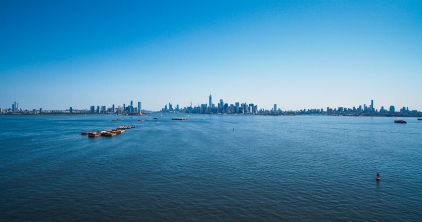Aerial Photo of Manhattan Island with Office and Apartment Buildings. Hudson River Scenery with Yachts, Boats, One World Trade Center Skyscraper in the Middle of Skyline