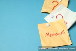 Scattered post it notes with the word “memories” in blue room, copy space 4mr77b