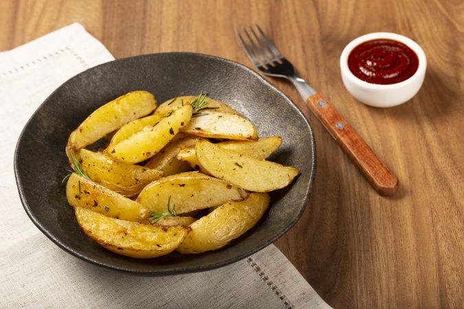 Roasted potatoes with rosemary on the plate.