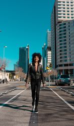 Woman with afro hair walking through the streets