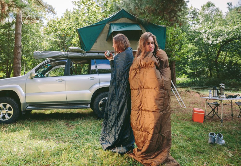 Women awakening inside of sleeping bags