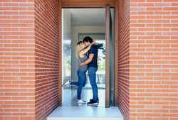 Couple kissing at the entrance