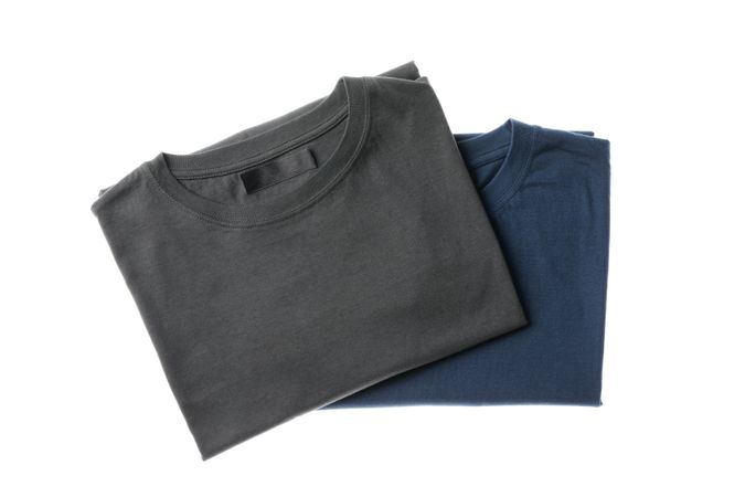 Folded t-shirts isolated on plain background, space for text
