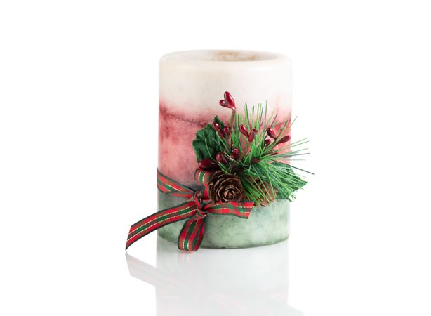 Seasonal Christmas candle isolated on a plain background