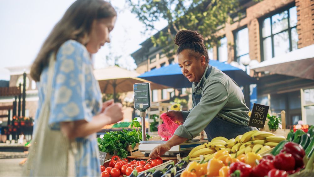 Black Female Running a Small Business on a Farmers Market, Selling Organic Fruits and Vegetables
