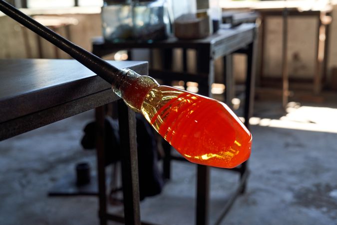 Molten glass on edge of pontil at factory