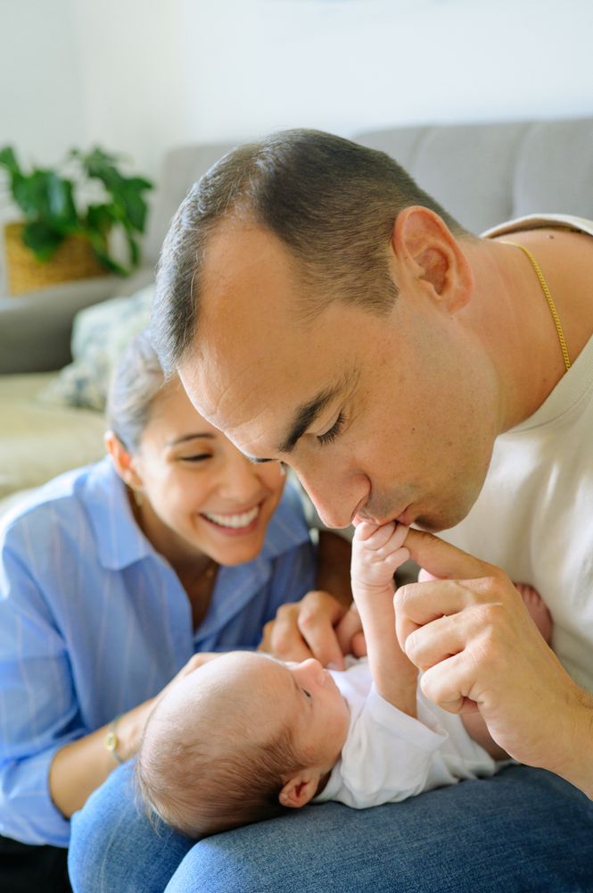 Happy parents communicating with infant in living room