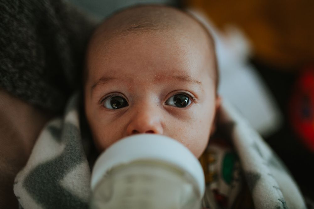 Newborn drinking from bottle