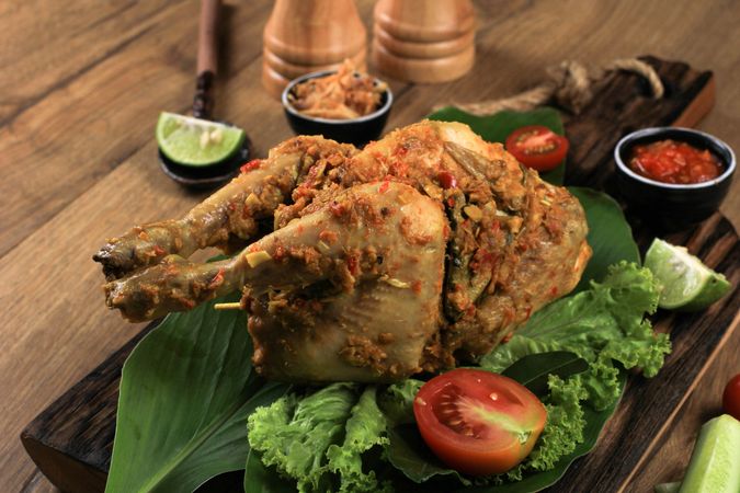 Ayam Betutu, Balinese Roast Chicken Stuffed with Cassava Leaves.