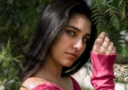Young charming woman between flowers