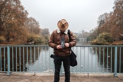Male tourist with vintage camera near river