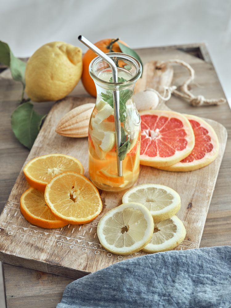 Bottle of refreshing drink and fruits