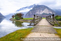 Bridge over lake with Austrian Alps in background 0WMoM4