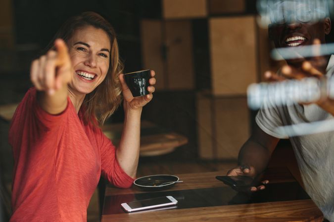 Smiling woman sitting with her friend at a coffee shop