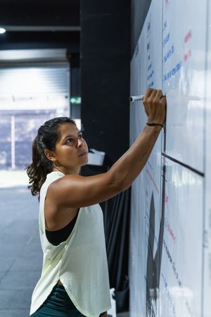 Sportswoman writing on board
