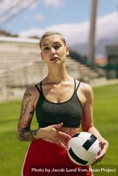 Portrait of female football player holding a ball on football field 41JNDb