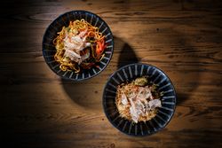 Delicious dishes in bowls served on wooden table